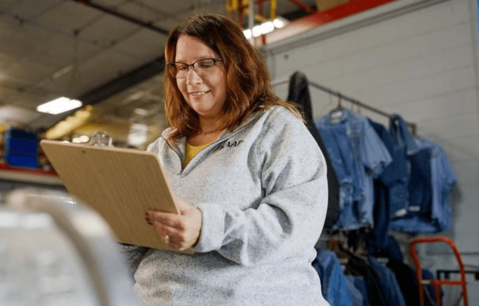 woman using clipboard in warehouse