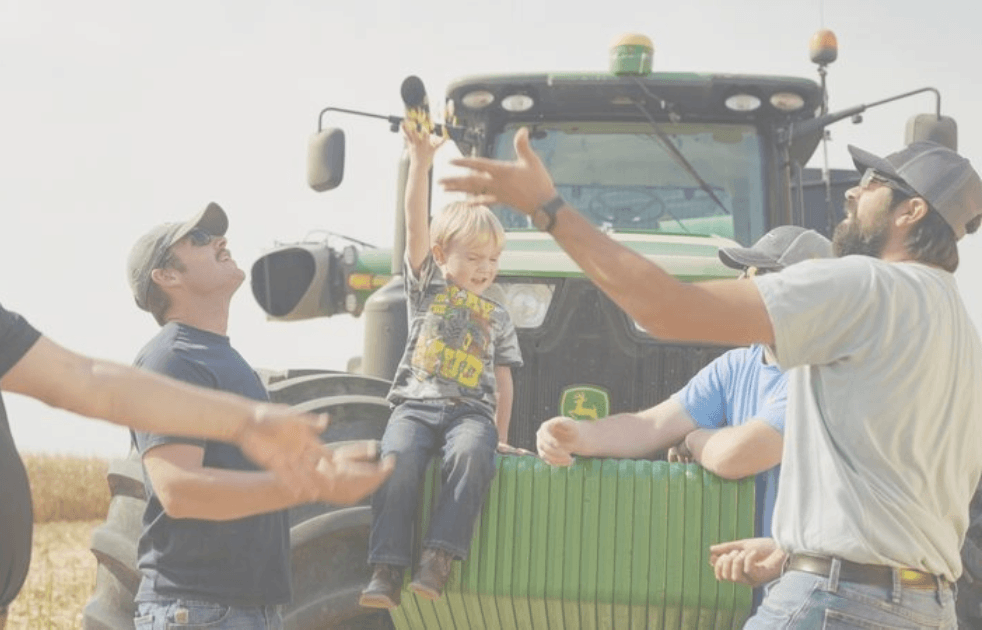 farmers in a field with corn
